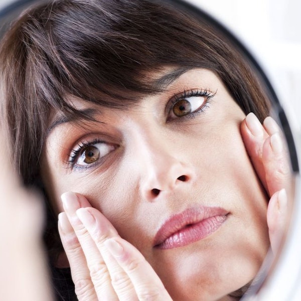 Woman looking into a mirror
