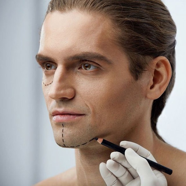Man getting marked on his face before a procedure